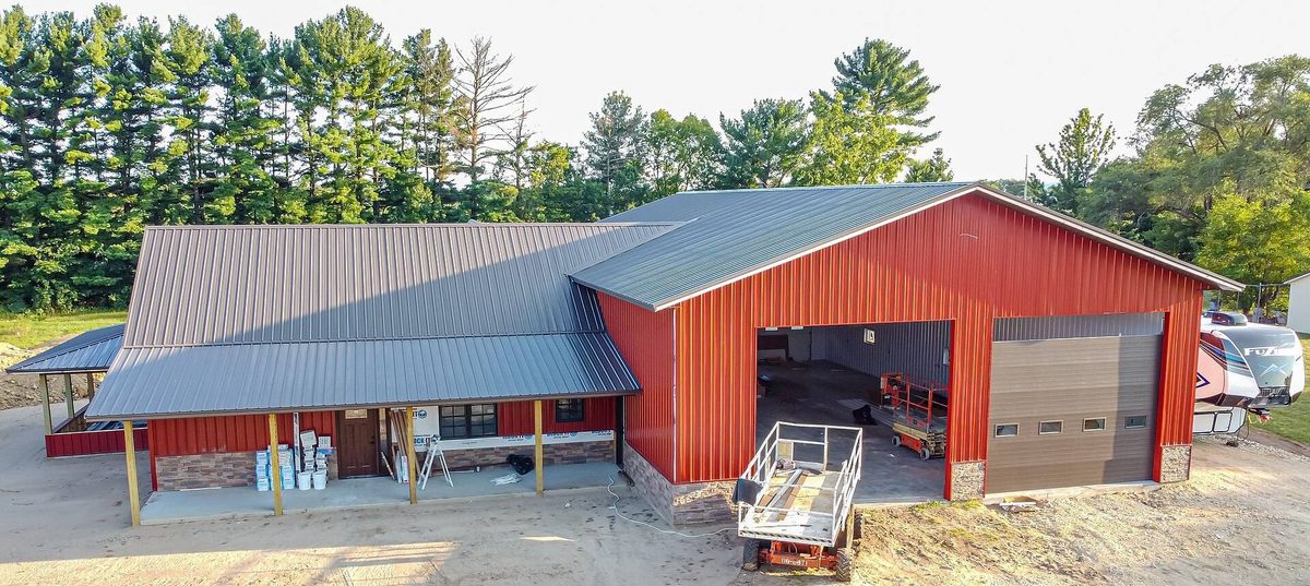 Red steel shop building with a gray metal roof